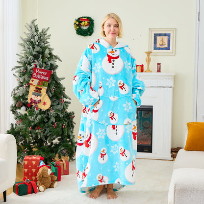 Person wearing a blue snowman-themed robe in a festive living room with a Christmas tree and fireplace.